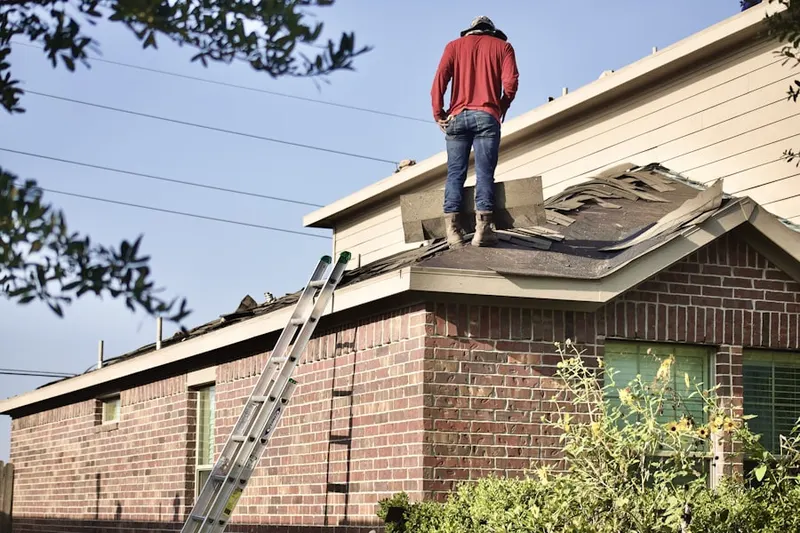 Professional roofer working on a residential roof in Trenton Mill